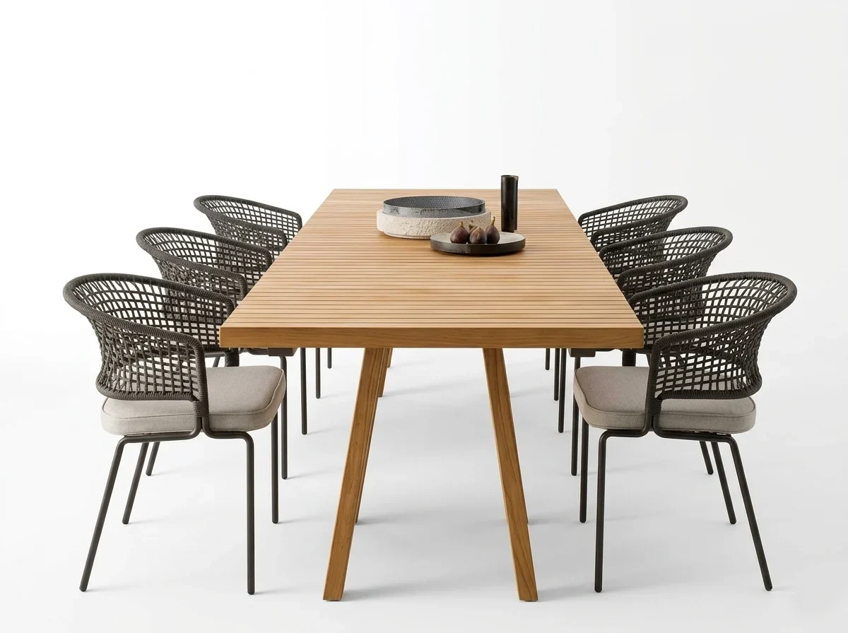 Modern outdoor dining set on white background featuring a rectangular slatted teak wood table and six dark grey woven armchairs with light grey cushions